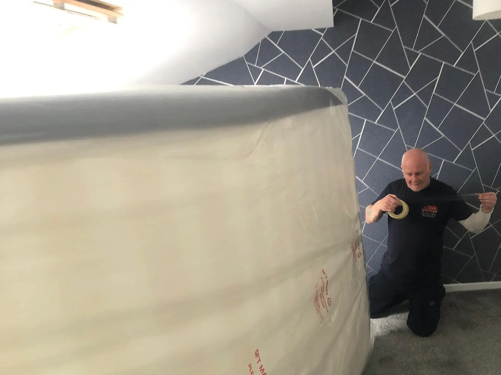 On The Move Removals packing a bed with professional materials