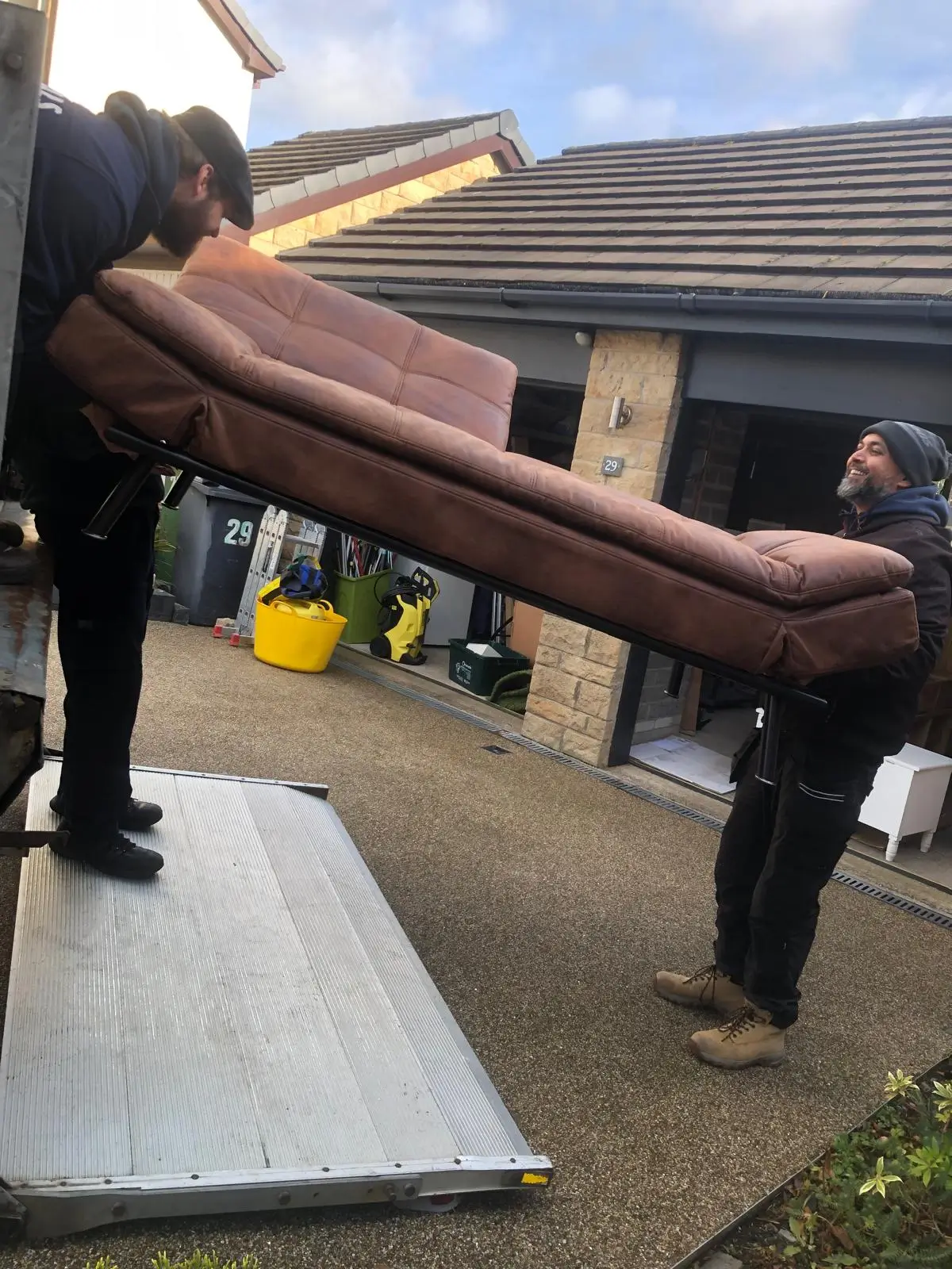 On The Move Removals team carrying a sofa bed to the van during a Huddersfield removal
