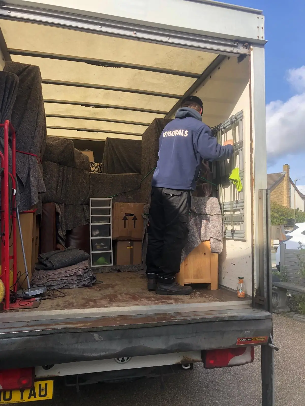 On The Move Removals team on the back of the van after loading a Huddersfield move