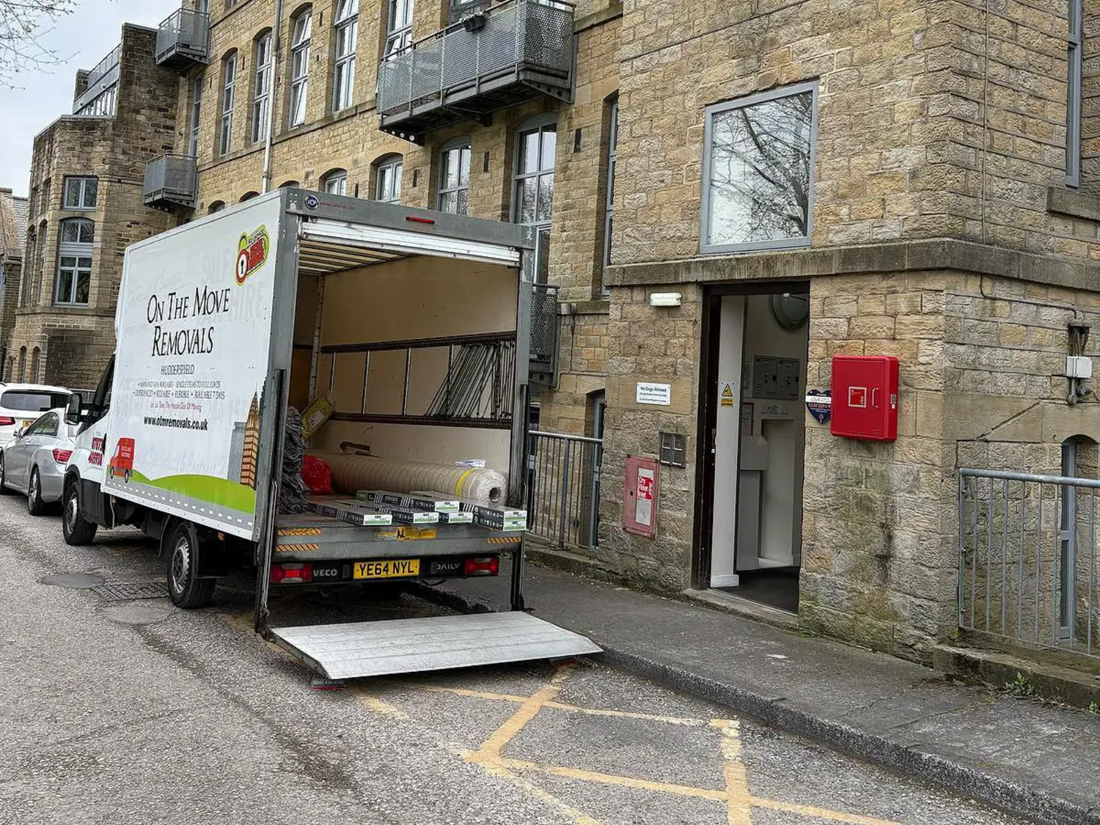 On The Move Removals van outside a block of flats for a Huddersfield apartment removal