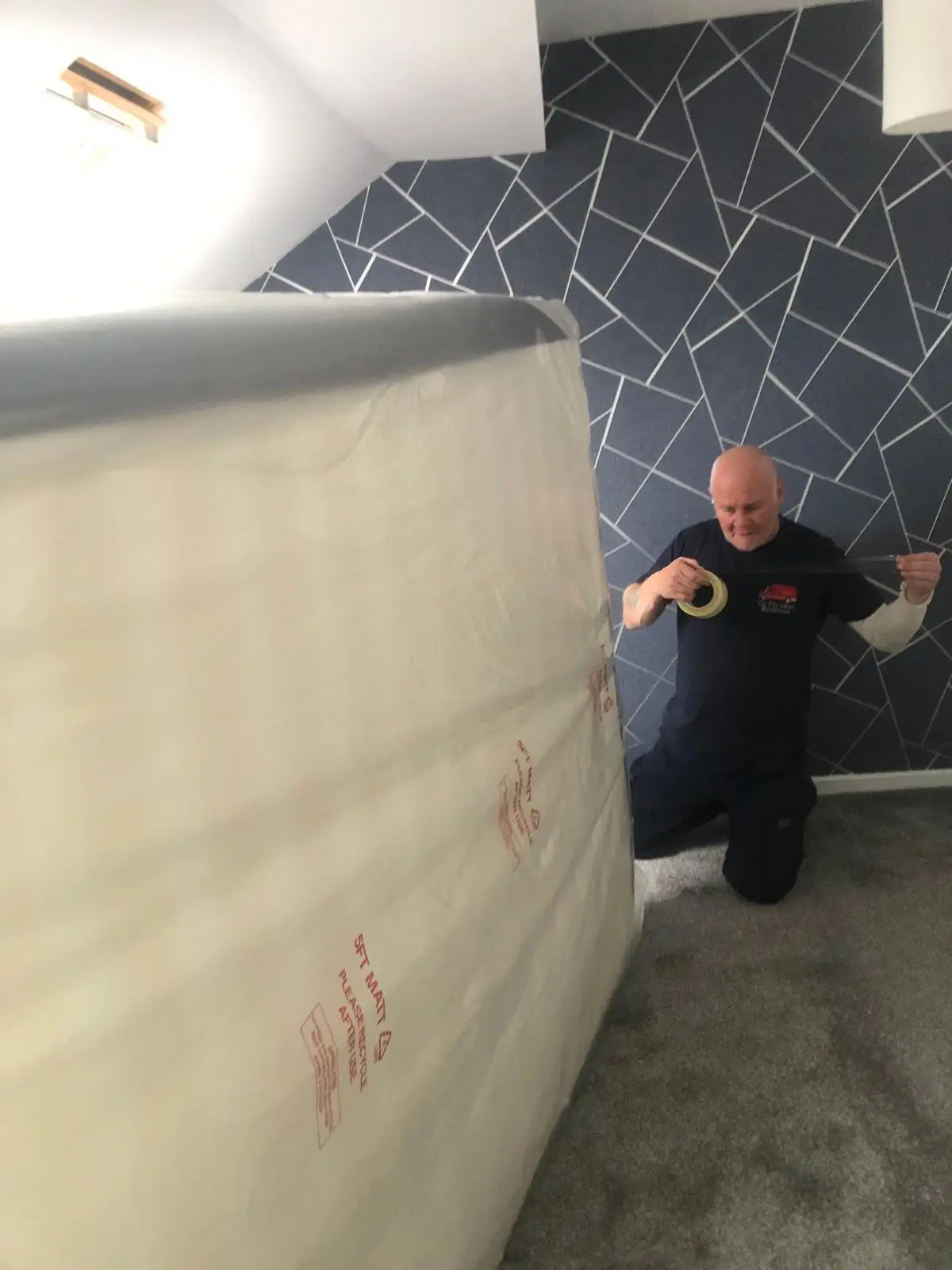 On The Move Removals team member wrapping and protecting a bed before a Huddersfield house move